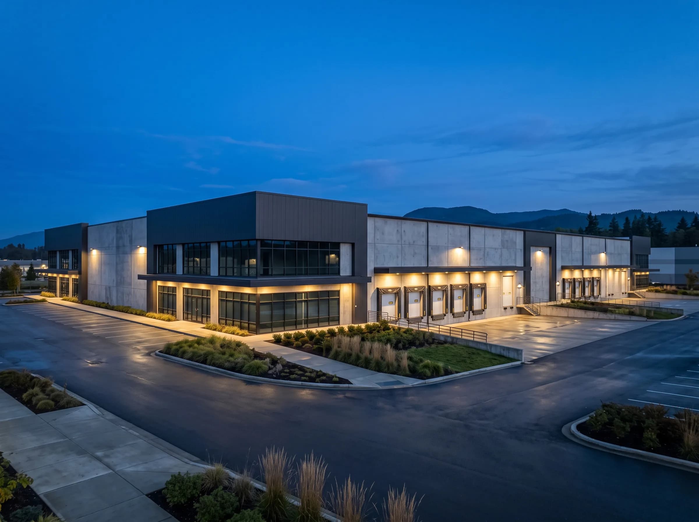 A modern West Coast commercial building at blue hour